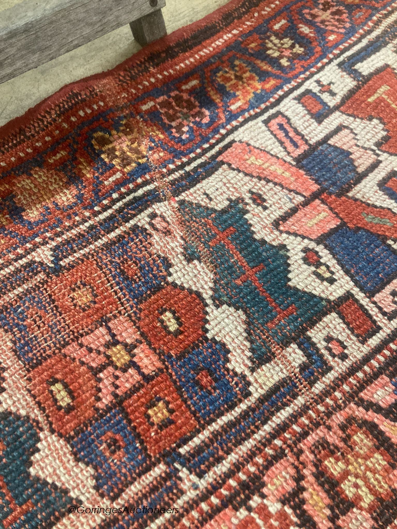 A Caucasian red ground rug, 218 x 112cm